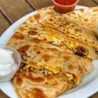 Sausage Breakfast Quesadilla · Made with 3 fresh eggs, sausage, mixed shredded cheese, sour cream on the side and salsa on ...