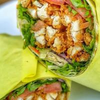 Crispy Chicken Wrap · Hand-breaded chicken tenders fried to perfection! Includes mixed greens, diced tomatoes, shr...