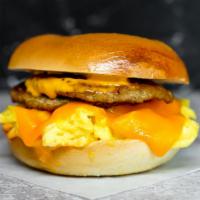 Bagel, Sausage, Egg, & Cheddar Sandwich · 2 scrambled eggs, melted Cheddar cheese, breakfast sausage, and Sriracha aioli on a toasted ...