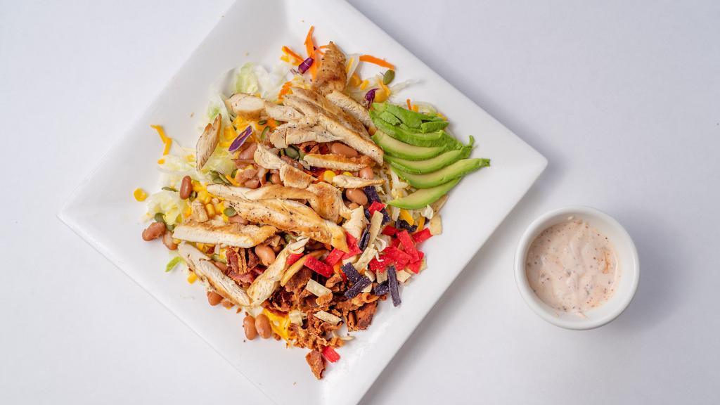 Santa Fe Chicken Salad · Our take on the Classic Santa Fe Salad, served with all white meat chicken breast. Comes with pot-boiled beans, avocado, corn, bacon, cheese, and tortilla chips. Comes with Chipotle Ranch.