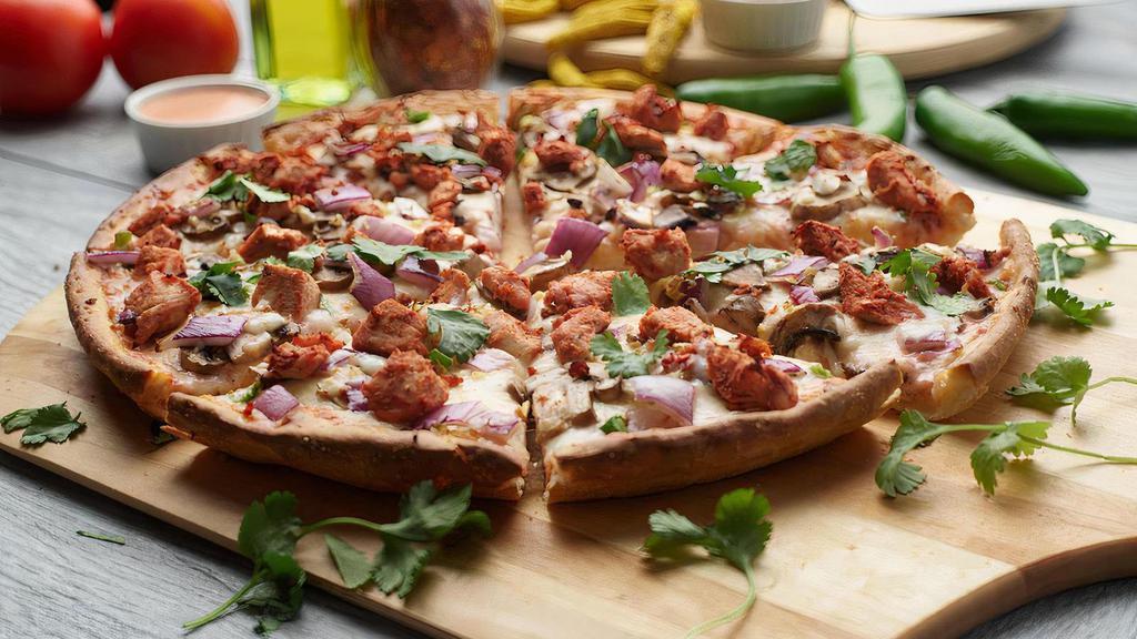 Halal Tandoori Pizza Twist · This pizza has our signature tandoori sauce, halal chicken, fresh diced mozzarella cheese, fresh  mushrooms, crisp red onions, fresh cut; garlic, ginger, and green chilies, garnished with fresh cilantro
