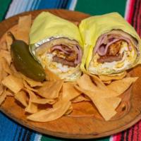 Breakfast Burrito · Egg, cheese, bacon, ham, link sausage and hash brown wrapped in a grill flour tortilla.
