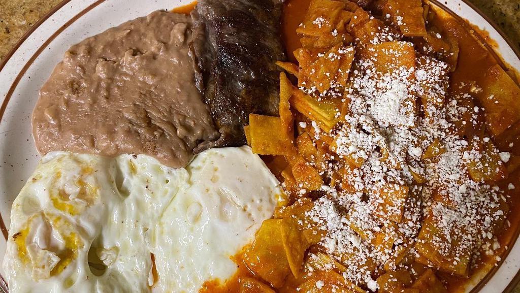Chilaquiles Con Carne Asada · **Customer Favorite!** Chilaquiles, with a Steak Carne Asada, and Eggs. Includes: Refried beans