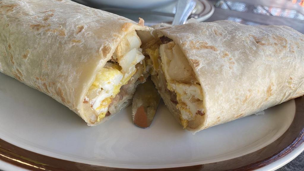 Machaca Burrito · Shredded Beef combined with scrambled eggs, bell peppers and onions and refried beans