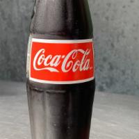 Mexican Coke · Mexican coke in a glass bottle, made with pure cane sugar. 355 ml