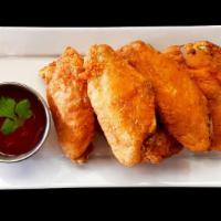 Chicken Wings · Deep-fried chicken wings served with sweet and sour sauce.