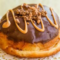 Reese’S Peanut Butter  · A chocolate donut topped with Reese’s peanut butter cups crumb & filled with peanut butter.