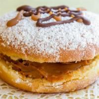 Dulce De Leche  · A powder sugared donut filled with a milky caramel and drizzled with milk chocolate and cara...