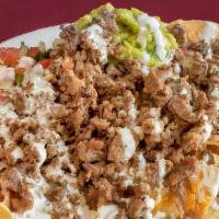 Nachos · Housemade chips, topped with beans, cheddar and Monterrey jack cheese mix, choice of meat, s...
