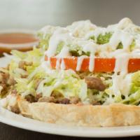 Sope · Handmade corn shell, toasted for texture, topped with beans, choice of meat, lettuce, tomato...
