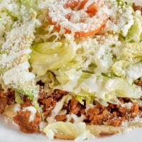 Huarache · Handmade corn shell, infused with pinto beans, toasted for texture, topped with mild green s...