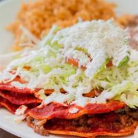 Enchilada Combination Plate · Three enchilada plates topped with lettuce, tomato, avocado, sour cream, and cheese. Served ...