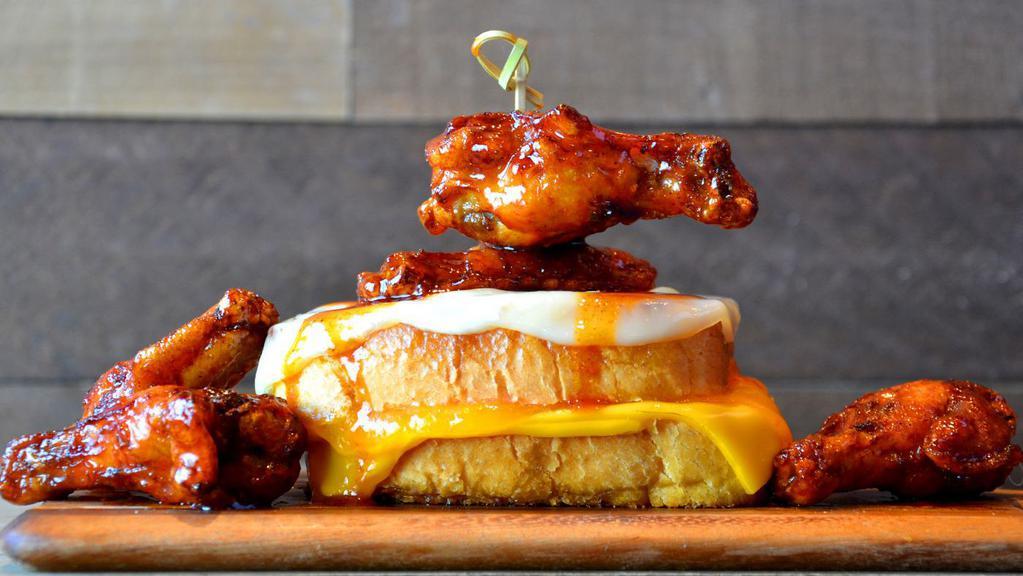 Triple Cheese And Wings · Provolone, American and cheddar cheese on classic Texas toast with hot honey chicken wings.