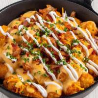 Loaded Tots · Bruxie Cheese Sauce, Applewood Smoked Bacon, Sour Cream, Chives