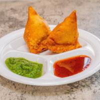 Vegetable Samosa · Crisp turnover, filled with mildly spiced potatoes and peas deep-fried.