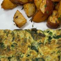 Green Omelette · Spinach, green onions, parsley, cilantro with roasted potatoes, and French baguette.