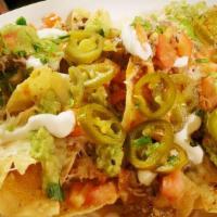 Nachos Mexicanos · Choice of shredded beef, ground beef, chicken, carne asada or carnitas. Served with beans, s...