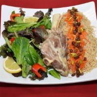 Qabuli Palow With Lamb Shank · Lamb shank with afghan rice, topped with carrots and raisins. Includes basmati rice and salad.
