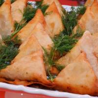 Veggie Samosa · Fried dish with filling and spices.