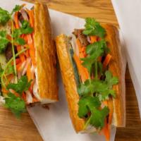 #14. Thịt Nướng (Grilled Pork) · French baguette filled with pork garnished with cucumber, cilantro, pickled vegetables (carr...