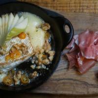 Honey Baked Brie · Served with prosciutto, apples, toasted walnuts, pickled kumquat, toasted baguette.