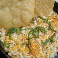Esquite Cups · Yellow corn, sour cream mayo mix, tajin, cotija cheese, tortilla chip.