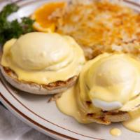 Eggs Benedict · Two poached eggs and Canadian bacon on an English muffin, topped with hollandaise sauce, ser...
