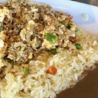 Machaca With Eggs · Eggs scrambled with slow roasted meat. Includes rice, beans, sour cream, and fresh bread.