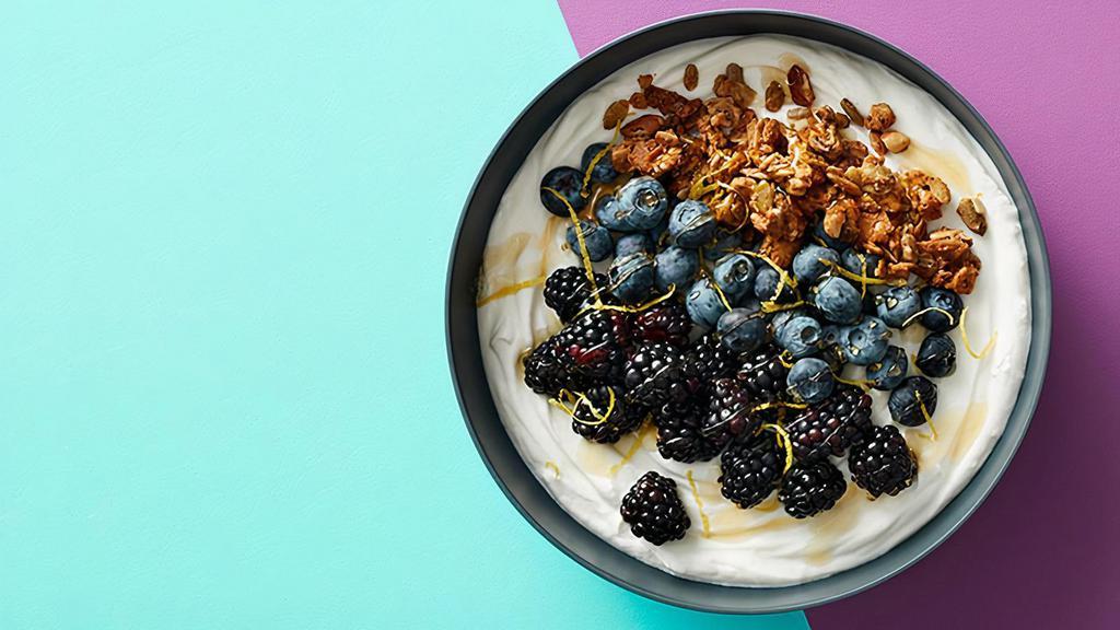 Yum Yum Yogurt Bowl · Acai bowl topped with  greek yogurt, granola, bananas, strawberries, blueberries, and agave.