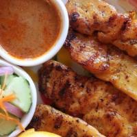 Chicken Satay · Grilled marinated chicken on skewers, served with peanut sauce and cucumber salad.