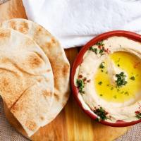 Hummus · Mashed chickpeas, olive oil, lemon juice, garlic, tahini, and special spices. Served with pi...