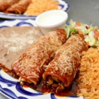 Chicken Enchiladas · Served with rice, beans & sour cream.