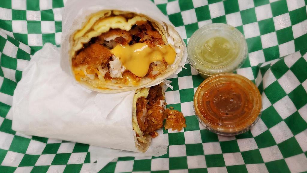 Chicken Breakfast Burrito · W/ Tater Tots , Chicken Tenders,  Eggs and Melted  Cheese.