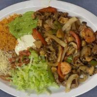 Mixed Fajitas Plate · Beef, chicken, Shrimp, Rice, beans, pico de gallo, guacamole, sour cream, lettuce and tortil...