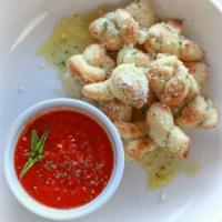 Garlic Knots · Baked pizza dough knots, dipped in a mixture of olive oil and garlic herb sauce, then sprink...