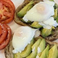 Avocado Toast · 2 poached eggs over avocado on rye with sliced tomatoes and sprinkled with crushed red peppe...