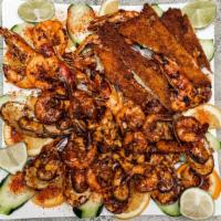 Parrillada De Mariscos (Seafood Grilled) · Langostinos/squat lobster, patas de jaiba/crab legs, camarones a la cora/cora style shrimp, ...