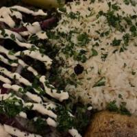 Beef Shawarma Sandwich · Tri Tip beef with onion-parsley mix, tomatoes, tahini sauce