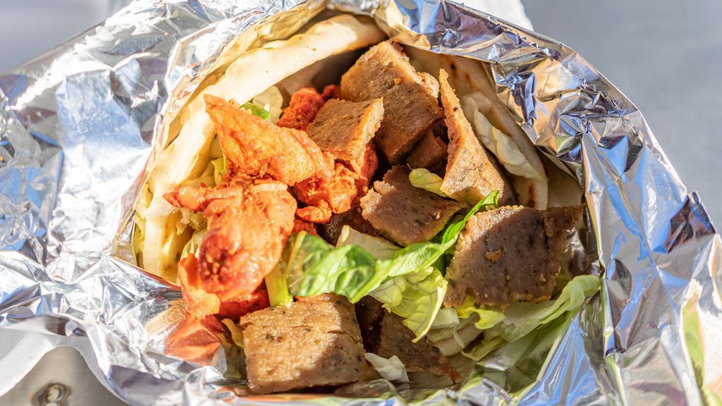 Habibi'S Gyro · The Habibi way -  A mix of our authentic lamb and chicken served on Pita with fries, lettuce, cucumbers, tomatoes, onions, pepperoncinis topped off with homemade tzitiki sauce, white sauce and hot sauce.