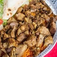 Lamb Platter · Lamb cooked with a vertical broiler the authentic way, served on Rice with salad, pita slice...