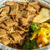 Steak Platter · Well seasoned steak meat served with Rice, salad, slices of Pita bread topped off with homem...