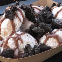 The Turtle (Half Dozen) · Powdered sugar donuts topped with caramel syrup and crushed Oreo cookies.