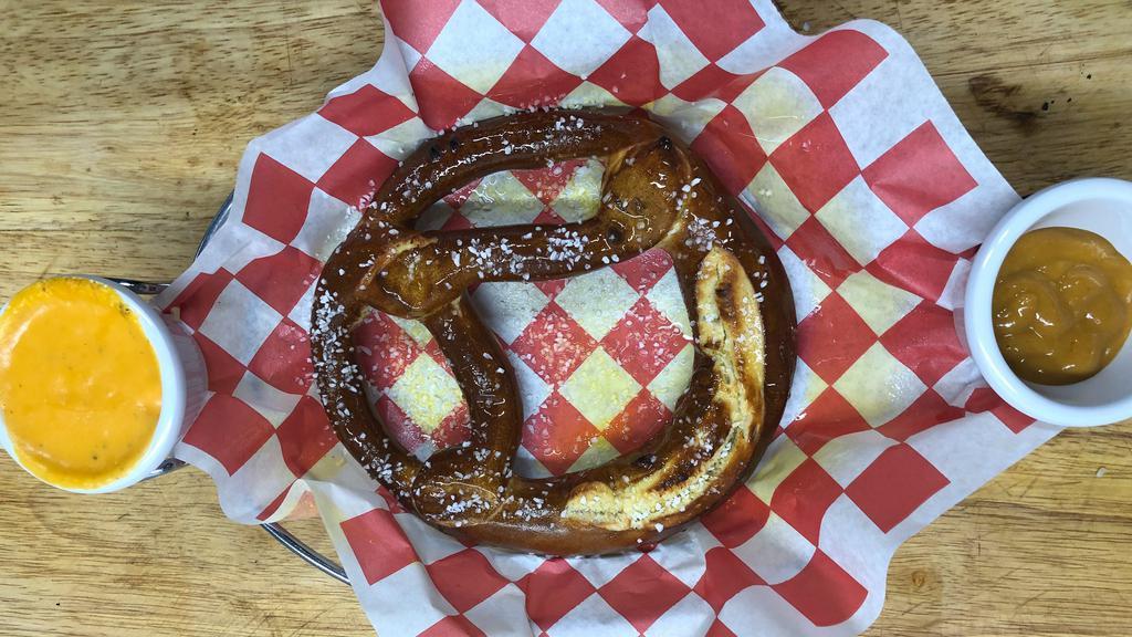 Hot Buttered Pretzel · Baked pretzel served with a side of beer cheese and spicy hot mustard.