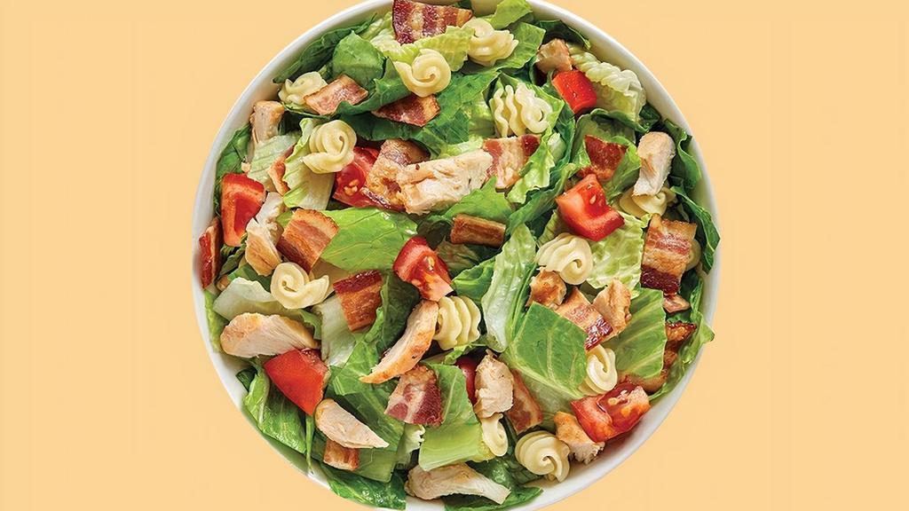 Roasted Turkey Club Salad · Our Roasted Turkey Club starts with a recommended base of Romaine/Iceberg Blend and Radiatore Pasta. It is served with Roasted Turkey, Smoky Bacon and Diced Tomatoes. We recommend our Ranch dressing.