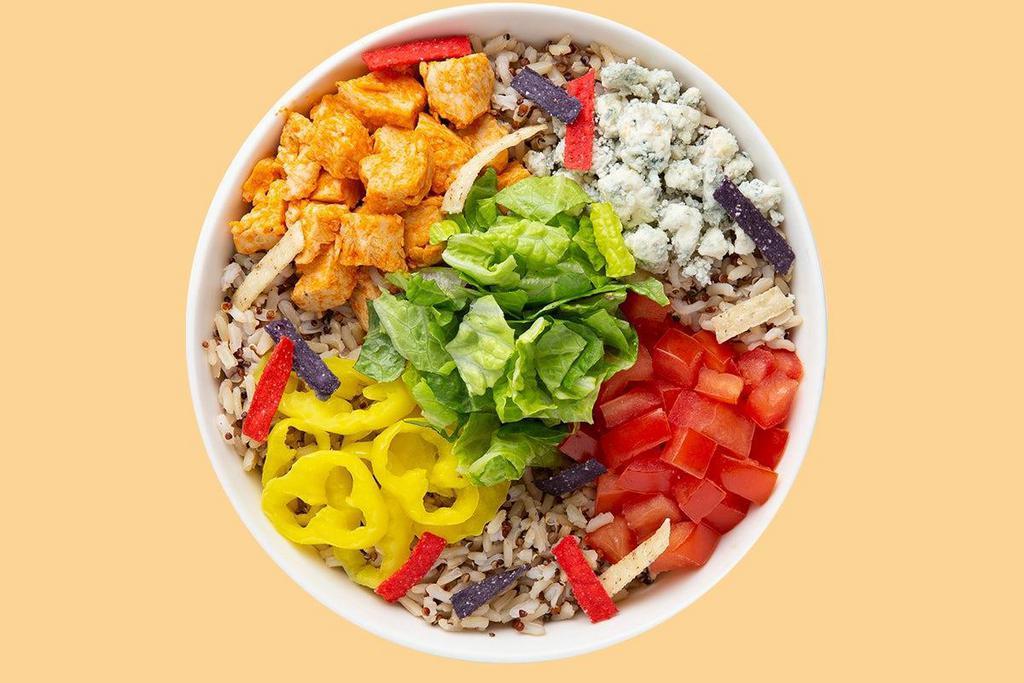 Buffalo Bleu Warm Grain Bowl · Our Chef starts with a base Super Grains Blend. It's served with Grilled Buffalo Chicken, Diced Tomatoes, Sliced Banana Peppers, Bleu Cheese and Tri-Color Tortilla Strips. We recommend our Creamy Bleu Cheese dressing.