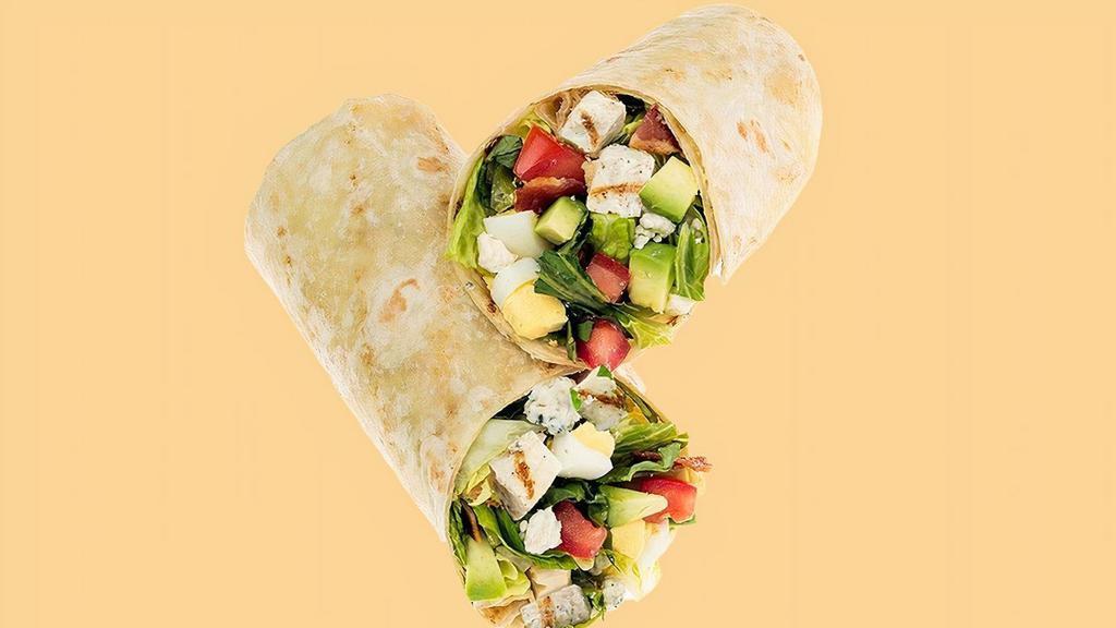 Avocado Cobb Wrap · Fresh Avocado enhances this timeless classic! Start with the recommended base of our Romaine/Iceberg Blend. It is served with Grilled Chicken, Diced Tomatoes, Fresh Avocado, Sliced Egg, Smoky Bacon and Bleu Cheese. We recommend our Thousand Island dressing.