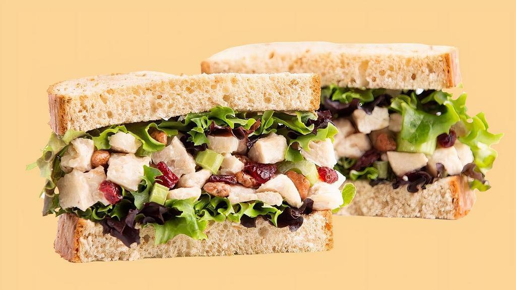 Cranberry 'N Pecan Chicken Salad Sandwich · Enjoy a taste of summer all year long! Our Chef-inspired, house made Chicken Salad with Chopped Celery, Dried Cranberries and Honey Roasted Pecans is piled high on a bed of fresh, crisp Spring Mix and served between two slices of our hearty Wheatberry bread.