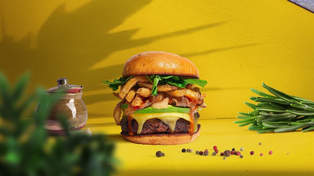 Locked And Loaded Burger · Seasoned Beyond meat patty topped with fries, avocado, melted vegan cheese, onion, lettuce, tomato, onion, and pickles. Served on a bun.