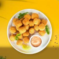 Food For Tots · Shredded Idaho potatoes formed into tots, battered, and fried until golden brown. Served wit...