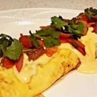 Omelette  · Omelette with sausage , tomatoes,  cheddar cheese, hash brown , and mild creamy chipotle sau...